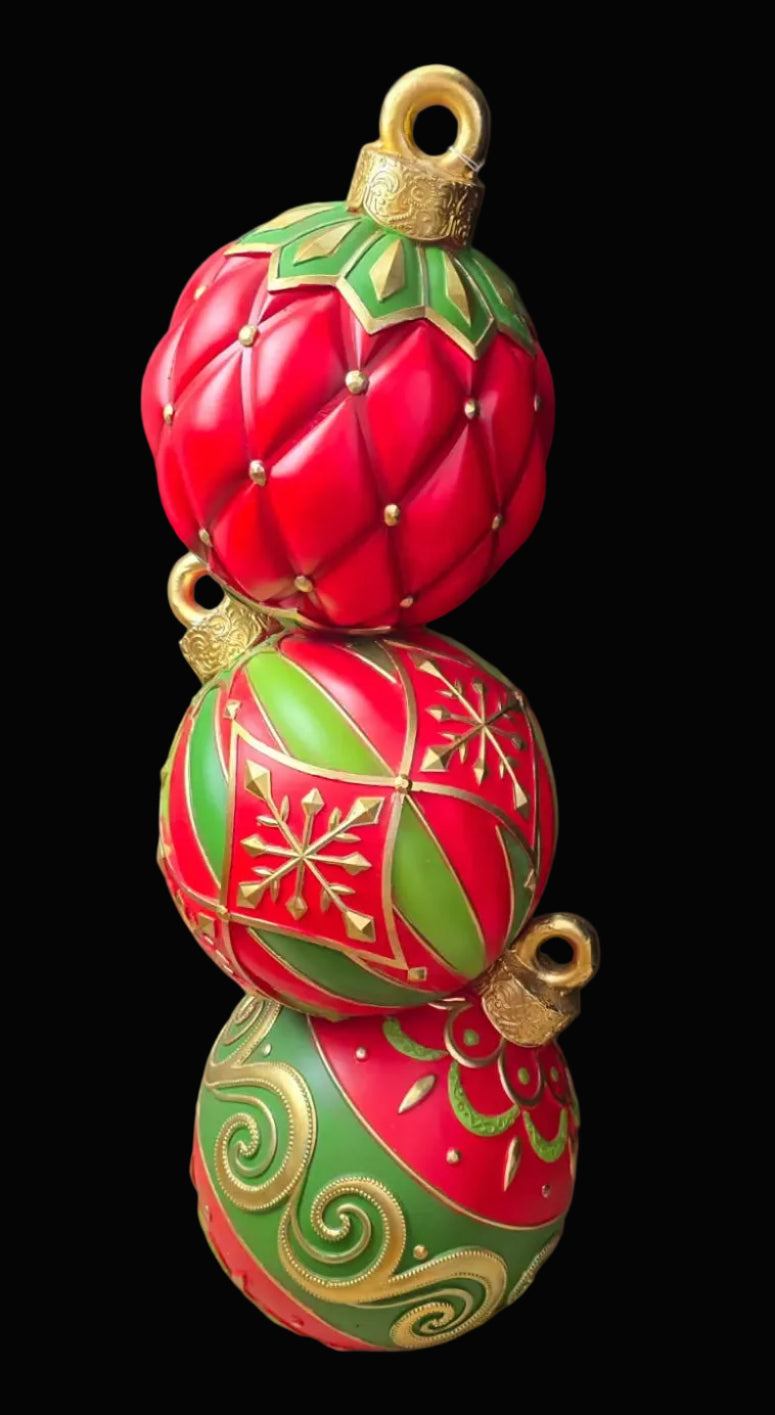 Decorative Christmas ornament with red and green design on a dark background
