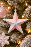 Pink glitter and mint-blue 3D star Christmas ornament hanging on a frosted Christmas tree with warm fairy lights and pink bauble — Mistletoe Home