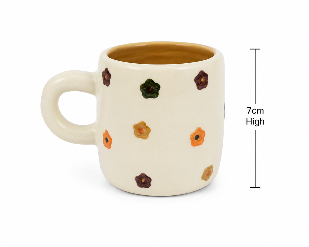 Cream ceramic kids mug with colourful flower dots on a plain background showing 7cm height measurement and mustard interior glaze