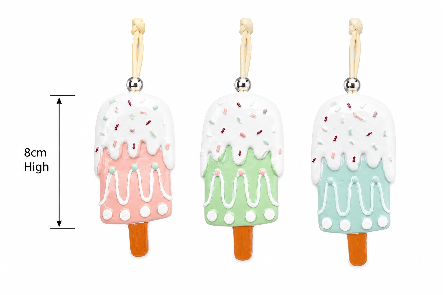 Pink, green and blue popsicle Christmas ornaments side by side on a plain background showing 8cm height measurement