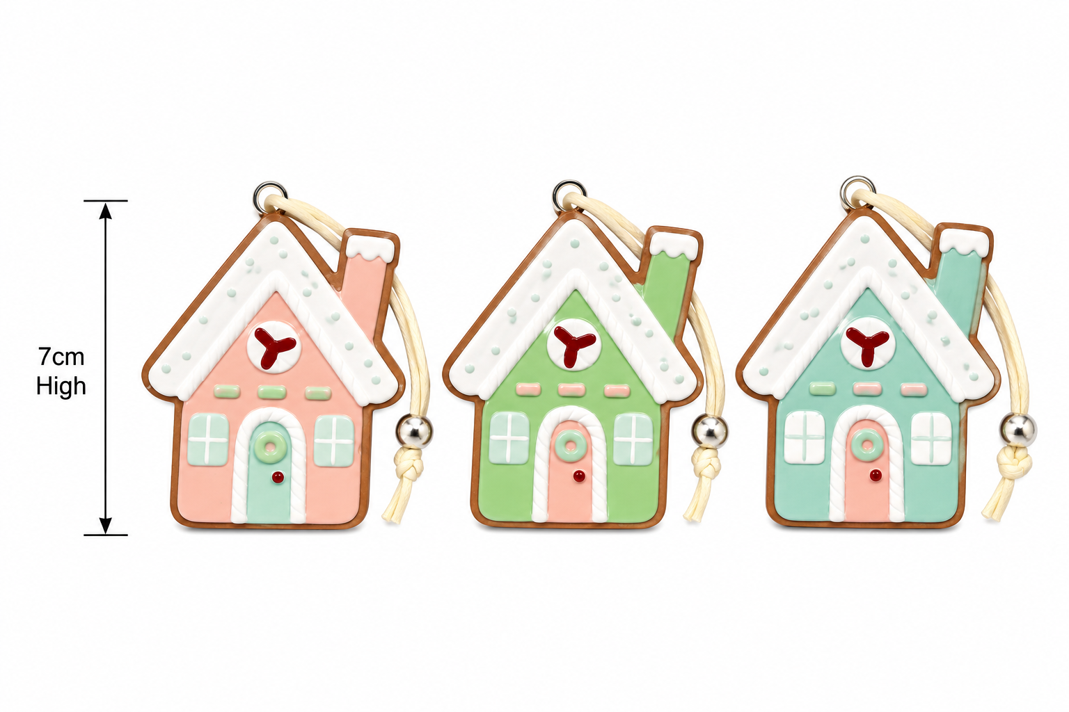 Pink, green and mint gingerbread house Christmas ornaments side by side on a plain background showing 7cm height measurement