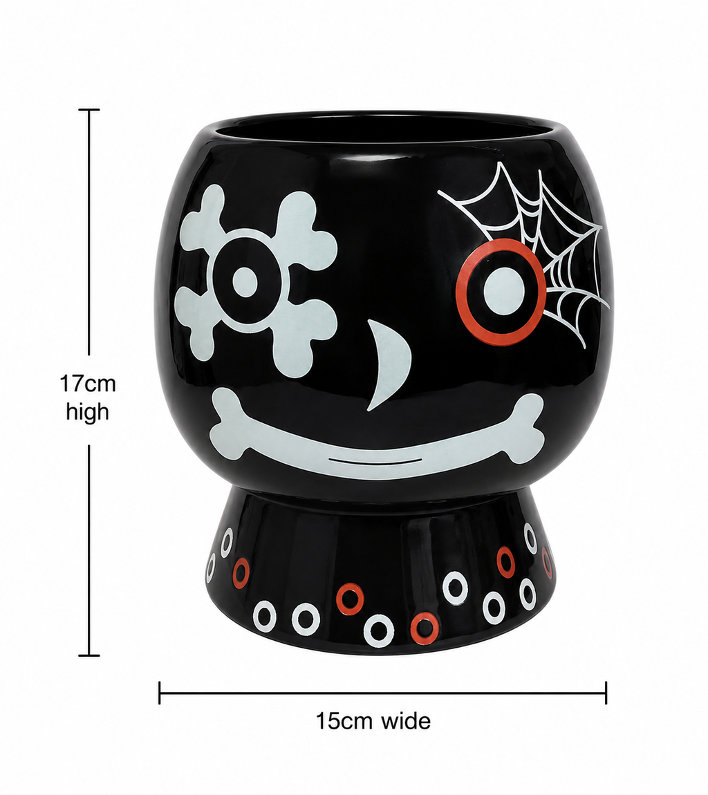 Skull and web ceramic plant pot on white background showing full design and pedestal base, with dimensions 17cm high by 15cm wide