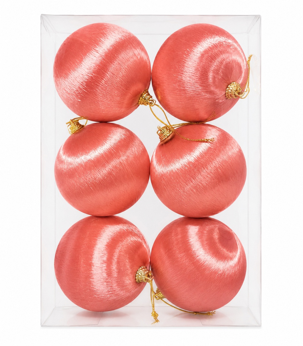 Set of six pink silk baubles in clear packaging box, arranged in two rows of three
