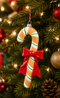 Gingerbread Candy Cane Hanging Ornament on a decorated Christmas tree with warm fairy lights, red baubles and pine cones