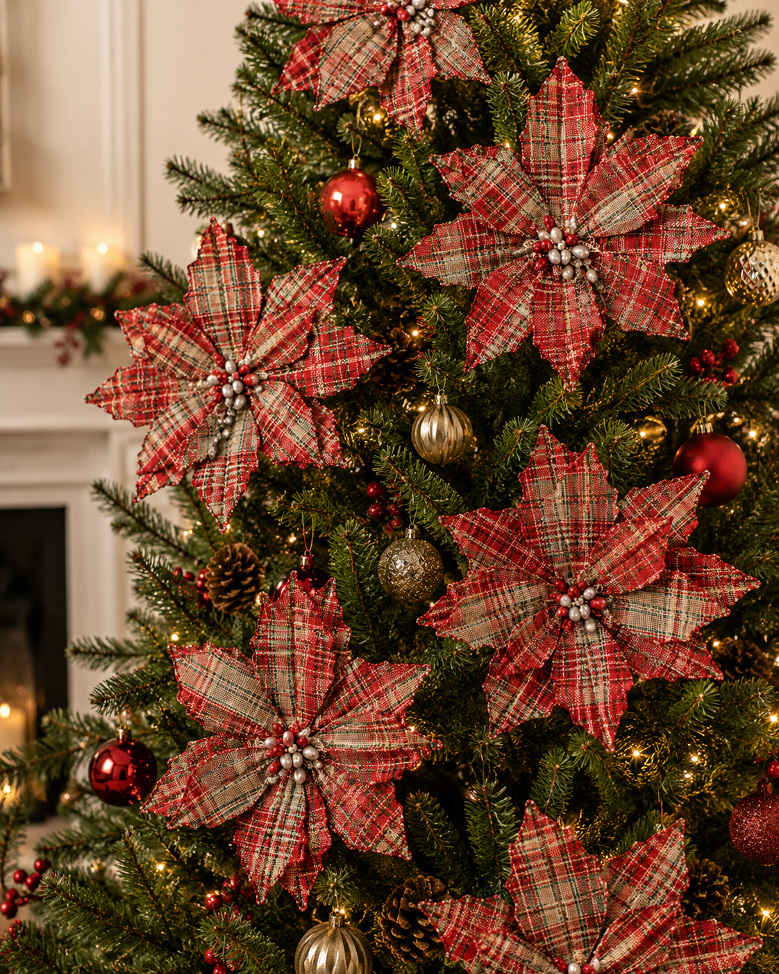 Tartan plaid poinsettia picks decorating a Christmas tree with red and gold baubles and warm fairy lights