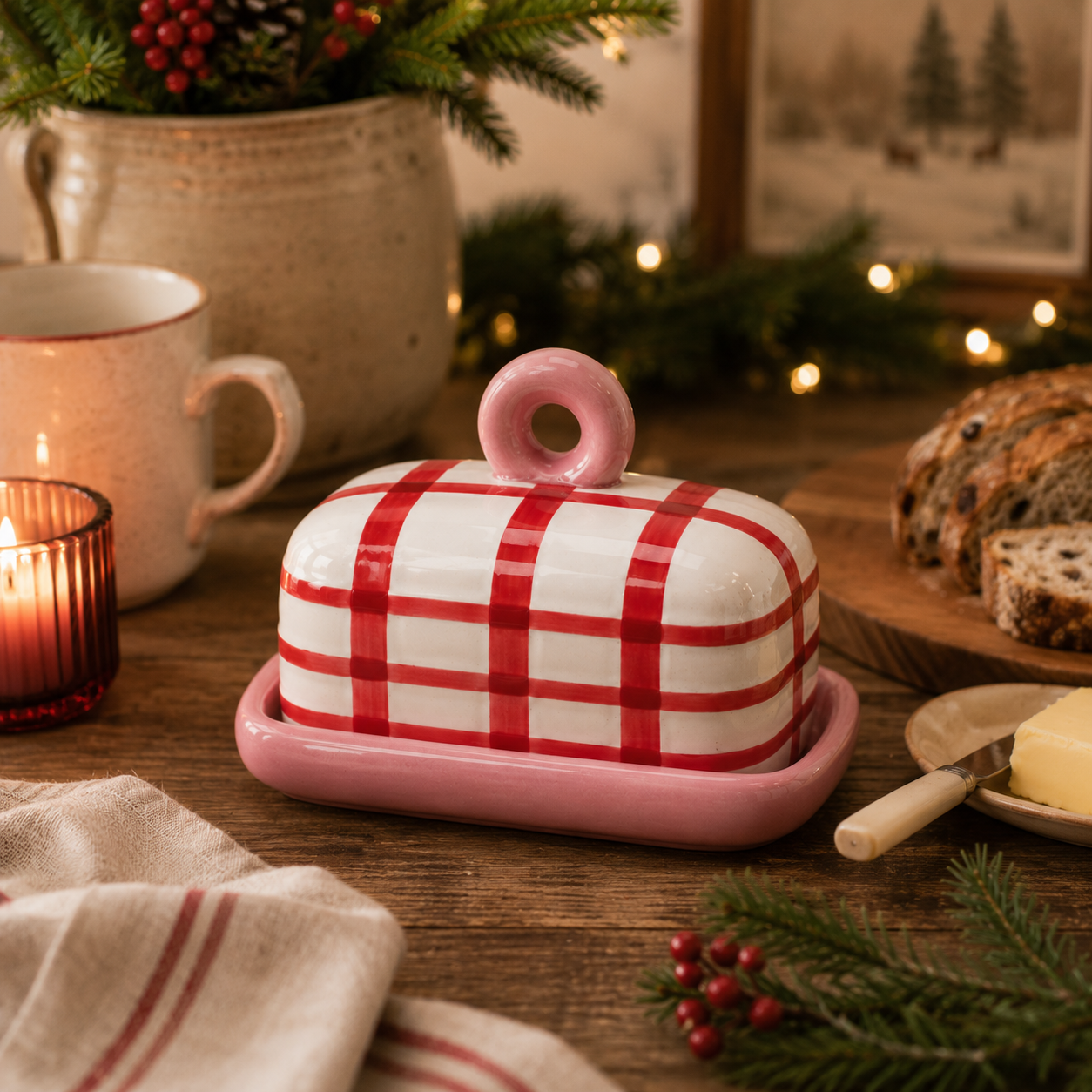  Red gingham butter dish styled in a cosy Christmas kitchen scene with candles, fairy lights, sliced fruit loaf and a butter knife