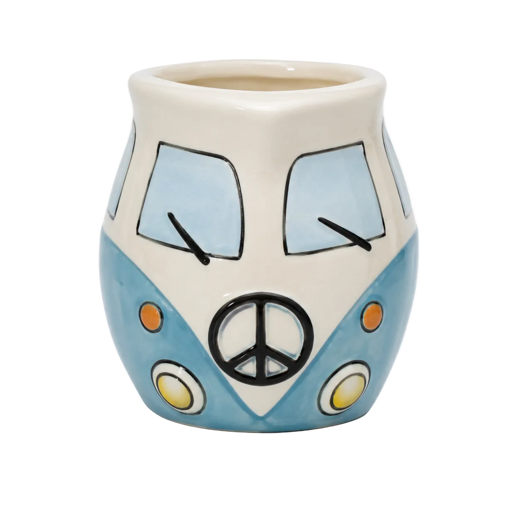 Blue and cream combi van shaped ceramic milk jug with peace sign and yellow headlights on white background