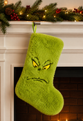 Grinch fluffy green plush Christmas stocking with embroidered scowling face hanging on a Christmas mantle — Mistletoe Home Australia