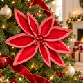 Red velvet poinsettia with red and white herringbone trim and glitter berry centre on a Christmas tree with warm fairy lights, baubles and red velvet ribbon