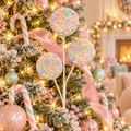 Pastel rainbow sprinkle lollipop stem with three bead-covered discs tucked into a flocked Christmas tree with candy canes, pink ribbon and fairy lights