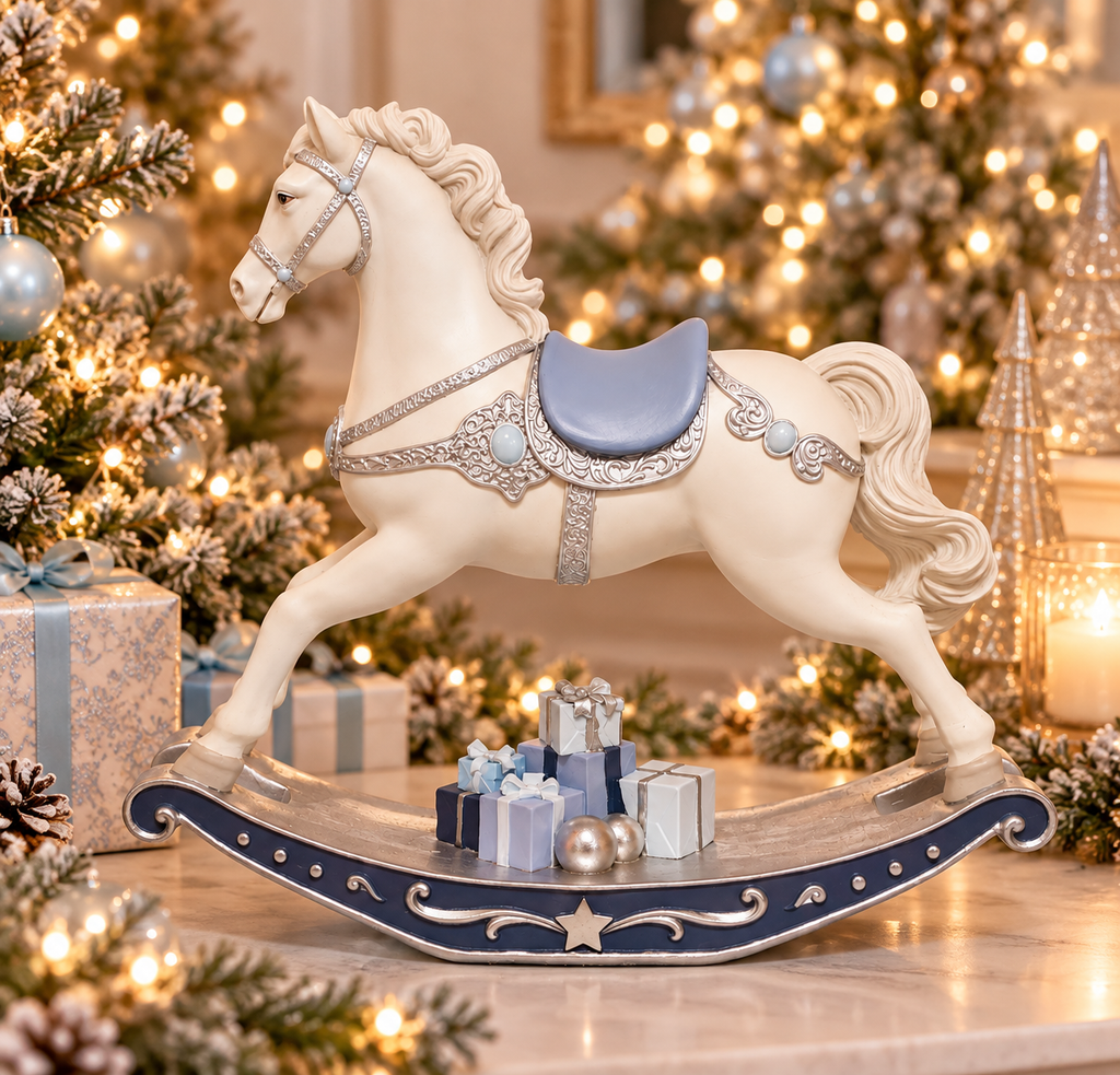 Ivory and navy rocking horse figurine with silver harness detail and gifts beneath the rocker, styled among Christmas trees and soft lighting