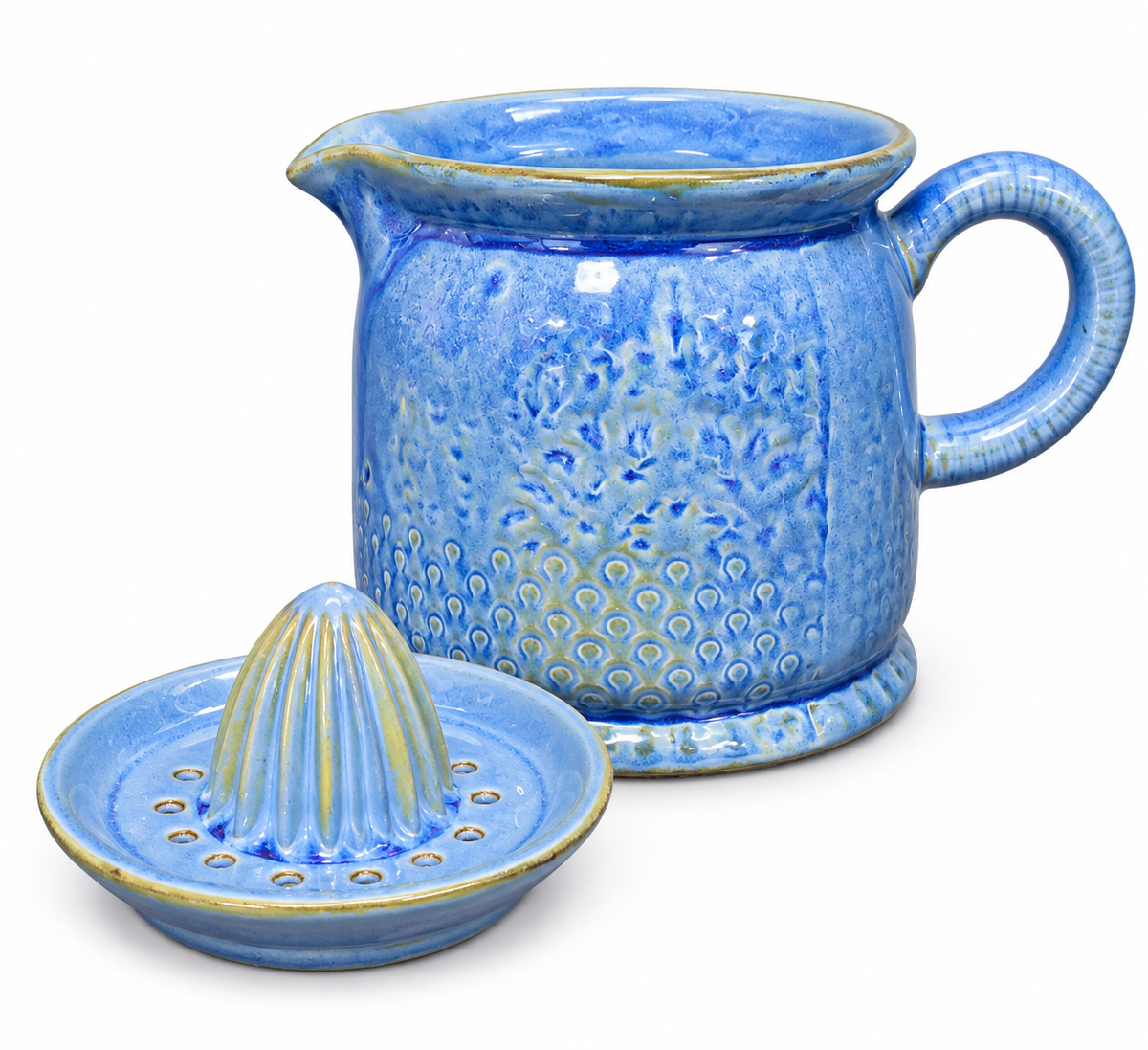 Blue ceramic citrus juicer shown disassembled on white background — pitcher base with pour spout and handle beside the separate perforated reamer top