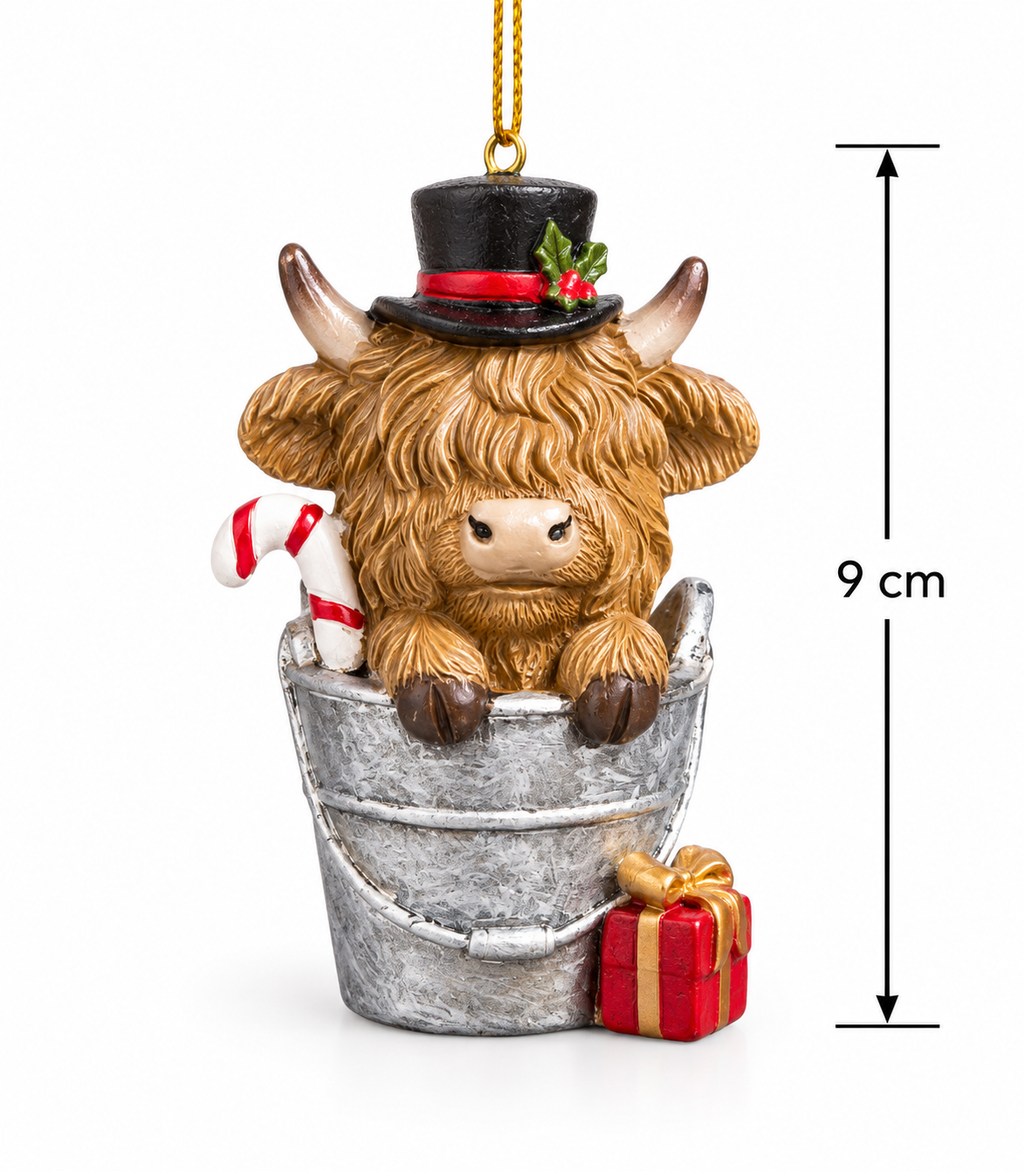 Highland cow in a bucket Christmas ornament on a white background with 9cm height measurement, showing full detail of the top hat, candy cane and gift box