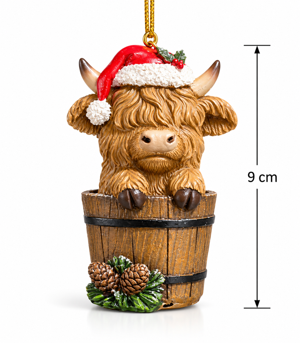 Highland cow in a bucket Christmas ornament on a white background with 9cm height measurement, showing full detail of the Santa hat, shaggy fur and pinecone wreath base