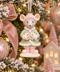 Mint green and pink star mouse Christmas ornament hanging on a decorated tree with pink ribbon and beaded garland