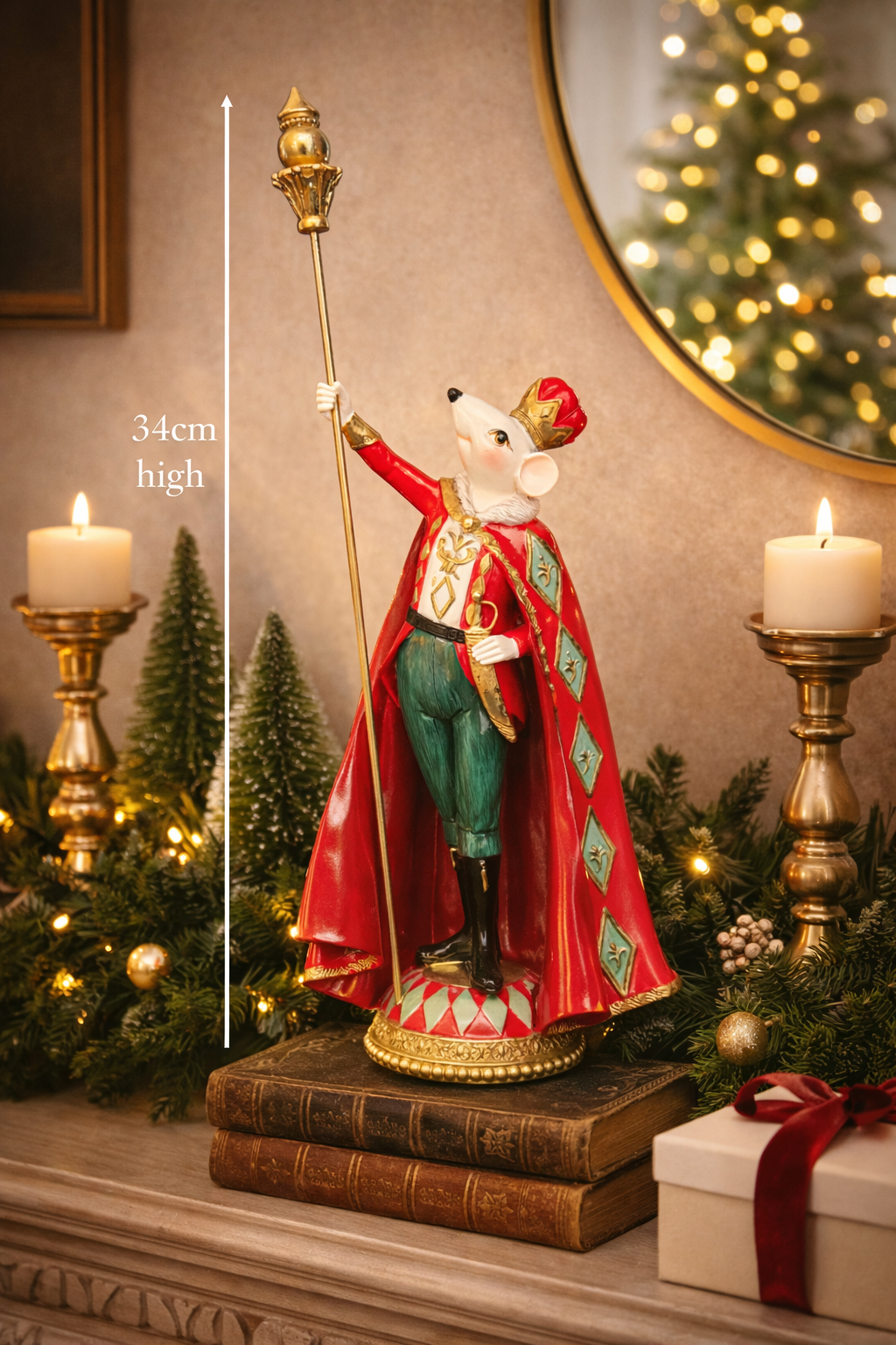  Hand-painted resin Rat King Christmas figurine in red cape, teal breeches, gold crown and sceptre, styled on a fireplace mantle with pillar candles, frosted garland, mini Christmas trees and a wrapped gift — 34cm high — Mistletoe Home