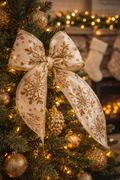 Gold snowflake wired ribbon tied in a bow on a decorated Christmas tree — Mistletoe Home Australia