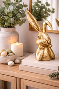 Wishful gold rabbit decorative figurine 39.5cm styled on books on a timber console with candle eucalyptus and Easter eggs — luxury home décor Australia Mistletoe Home