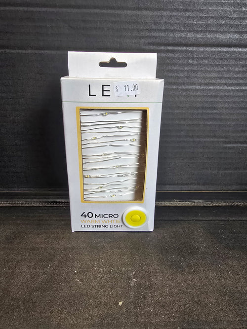 Lexi 40 micro warm white LED string light in white and gold retail packaging with silver wire lights visible through window — Mistletoe Home