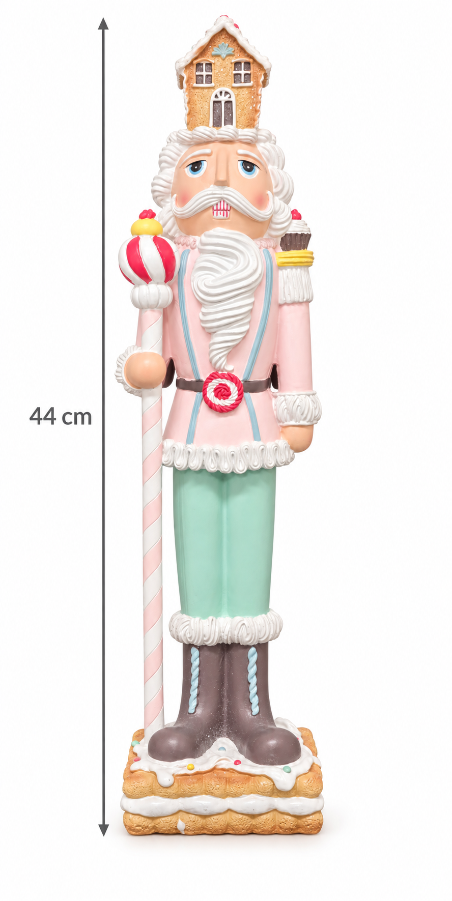 Pastel gingerbread nutcracker with a gingerbread house hat, icing beard, pink jacket, mint trousers and candy cane staff on a biscuit base, shown on a plain white background with a 44cm height measurement
