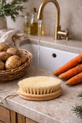 Wooden vegetable cleaning brush with natural bristles styled on a stone kitchen bench beside fresh carrots and potatoes with gold tap — Mistletoe Home Australia
