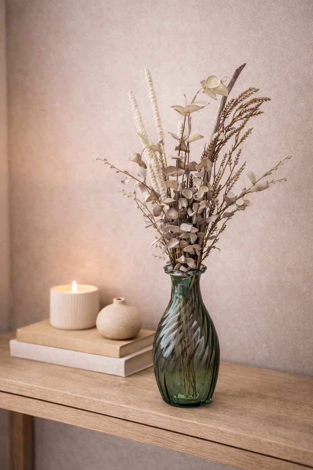 Neutral faux eucalyptus and wheat styling bunch in green glass vase on timber console with candle and books — boho home décor Australia Mistletoe Home