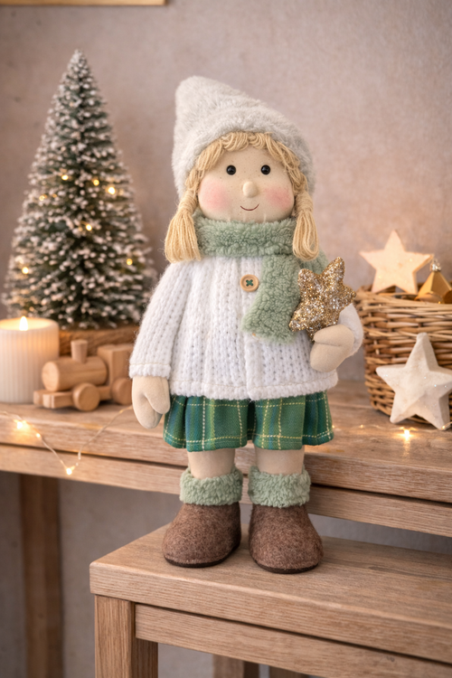 45cm standing Winter Girl Christmas decoration in knit sweater green tartan skirt and grey hat holding gold star styled on timber console with frosted Christmas tree and fairy lights — Mistletoe Home Australia