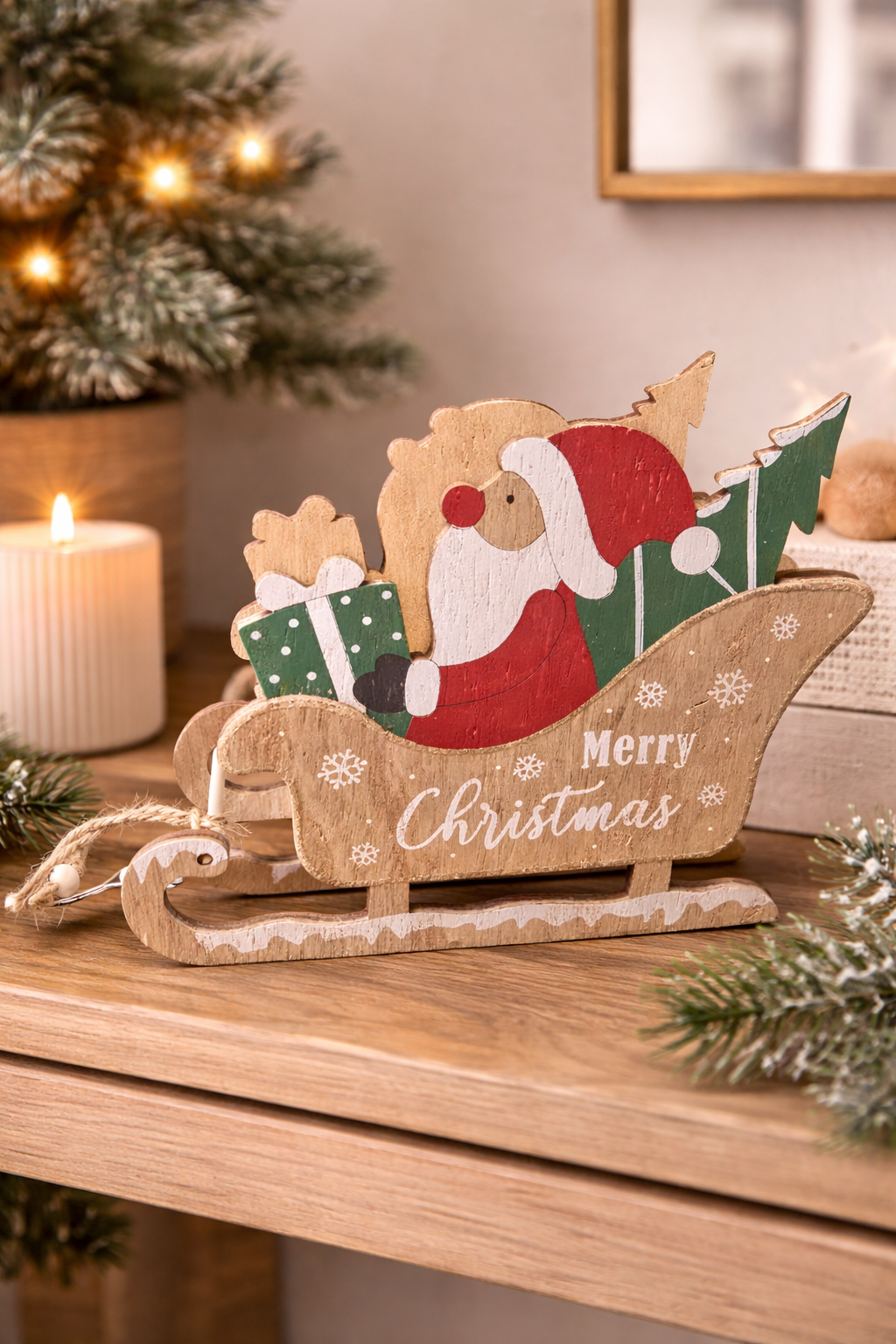 Wooden Santa sleigh Christmas decoration styled on a timber console with candle and Christmas tree — festive shelf décor Australia Mistletoe Home