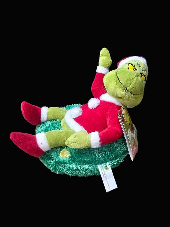 Plush toy resembling a character from a Christmas movie on a neutral background