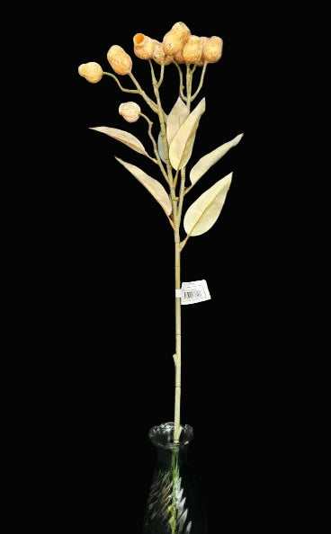 Artificial flower arrangement with a green vase on a dark background