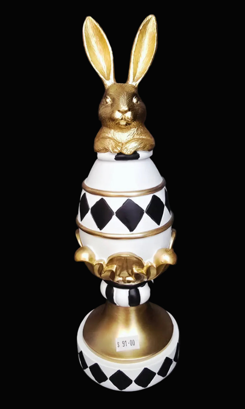 Decorative object with gold rabbit on a black and white checkered base