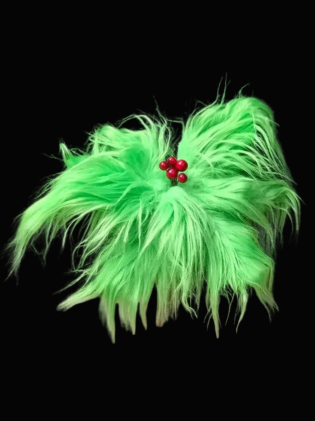 Green feathered flower with red berries on a black background