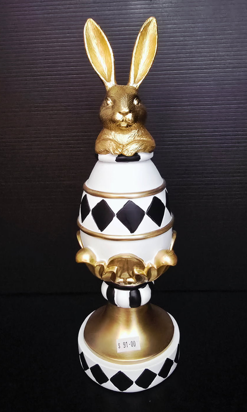 Decorative object with gold rabbit on a black and white checkered base
