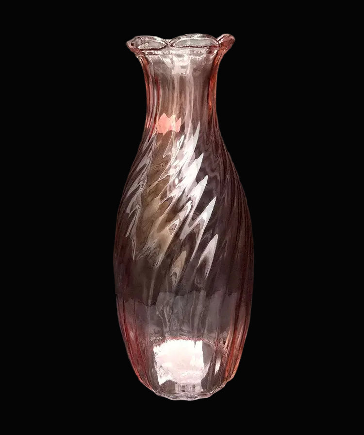 Pink twisted swirl glass vase with scalloped flared rim on black background — Mistletoe Home