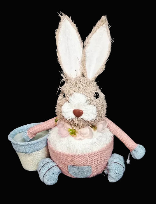 Plush rabbit toy with a pink dress and blue shoes on a dark background