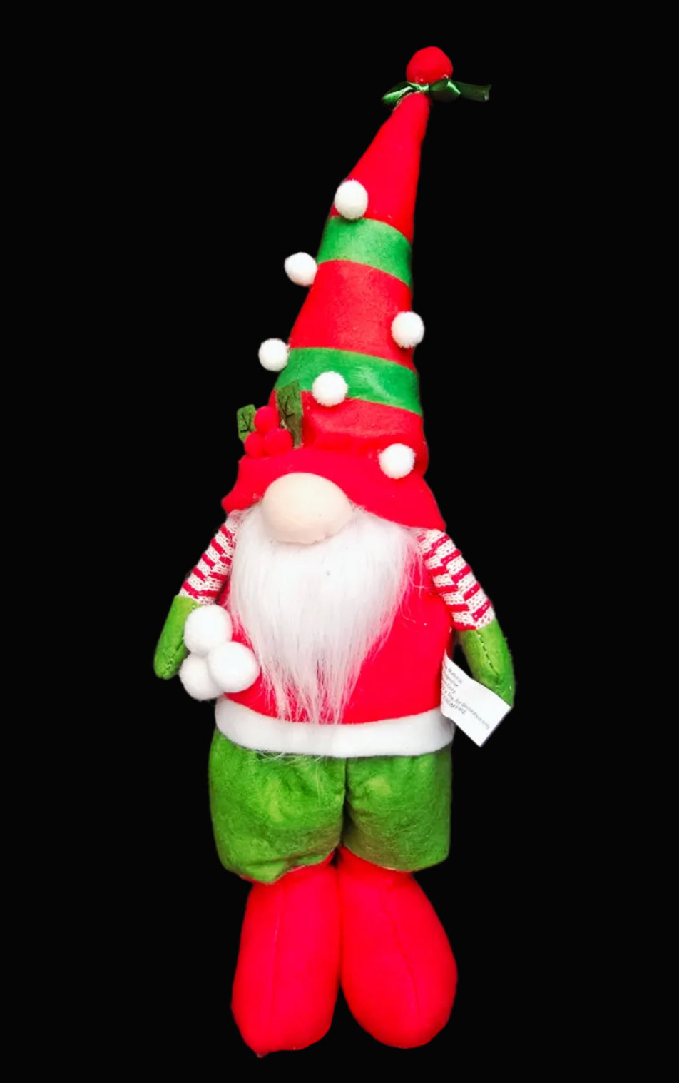 Standing fabric Christmas gnome in red and green with tall striped hat, white pom poms, holly berry topper, fluffy beard and red boots on black background — Mistletoe Home