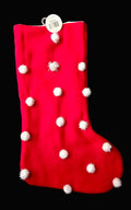 Red velvet Christmas stocking with white fluffy pom pom detail and hanging loop on black background — Mistletoe Home