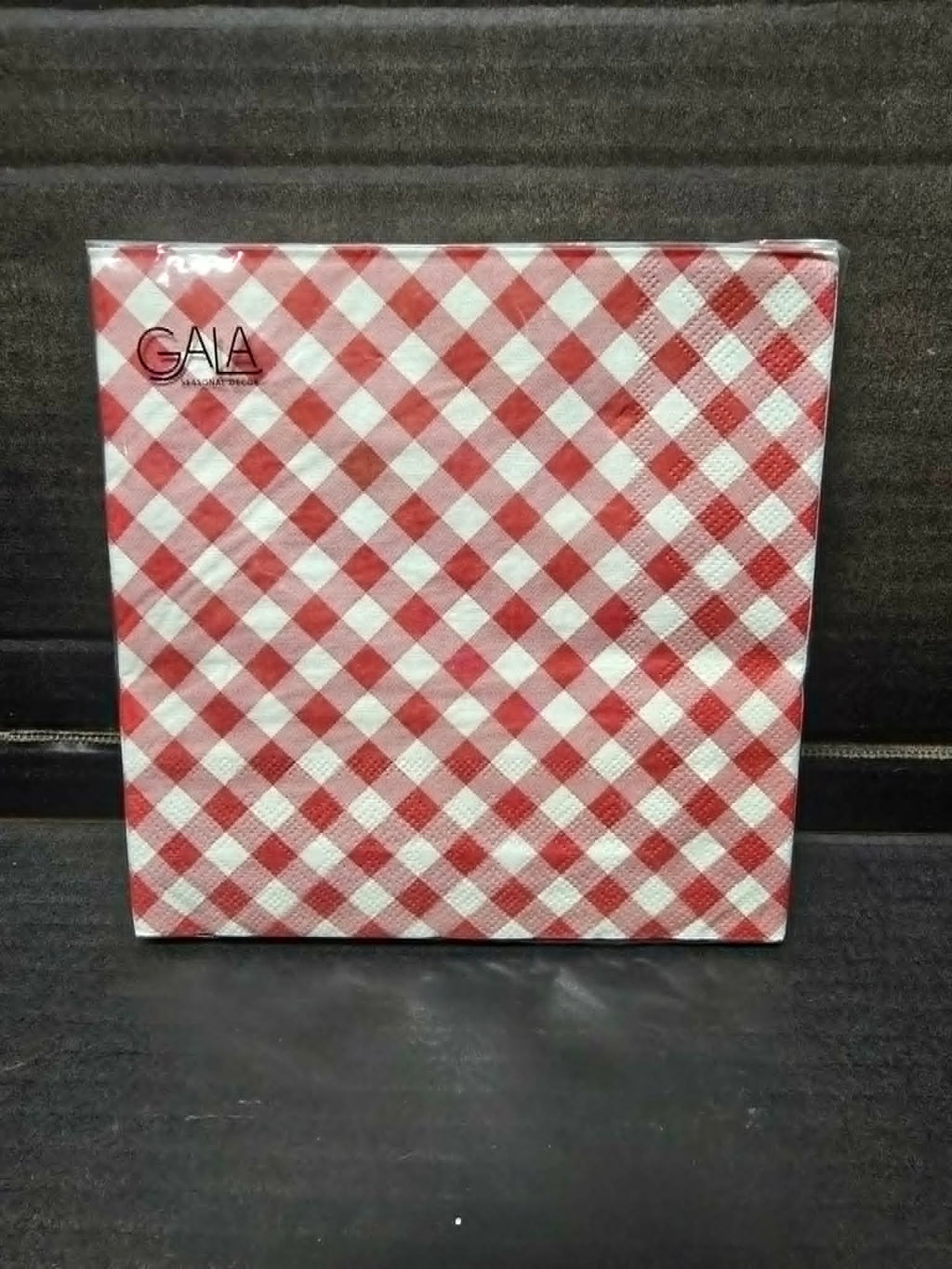 Pack of 20 red and white gingham print Gala paper napkins in clear packaging on dark background — Mistletoe Home