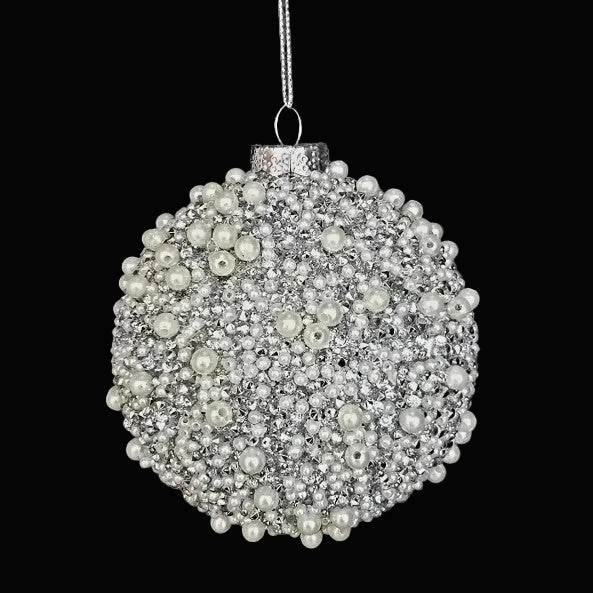 Decorative ornament made of pearls and crystals on a dark background