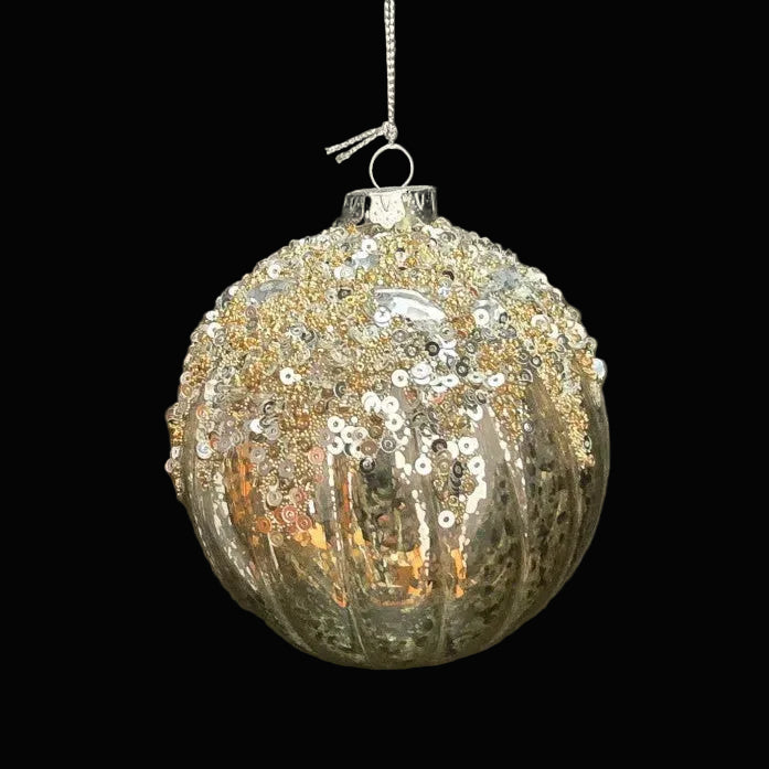 Decorative Christmas ball ornament with sequins on a dark background