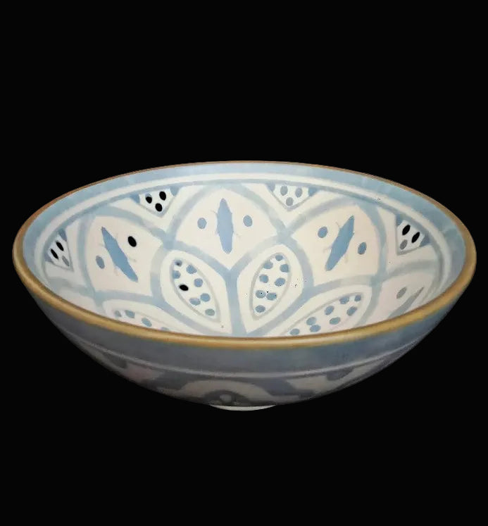Ceramic bowl with blue and white pattern on a black background