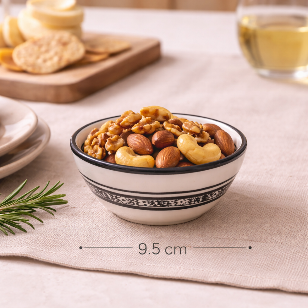 Black and white ceramic bowl filled with nuts styled on a wooden surface — Mistletoe Home Australia