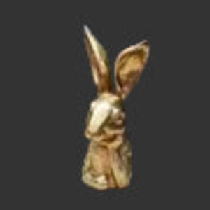 Gold resin thinking rabbit figurine with tall ears and antique gold finish in a seated contemplative pose on a dark background — Mistletoe Home