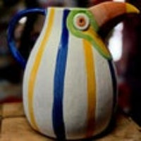 Hand-painted ceramic toucan jug in blue, yellow and white stripes with orange beak and green eye detail — Mistletoe Home