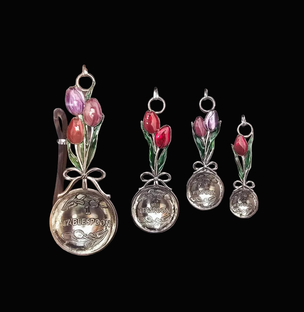 Set of four tulip measuring spoon set showing 1 tablespoon, 1 teaspoon, half teaspoon and quarter teaspoon with enamel tulip bouquet handles — Mistletoe Home