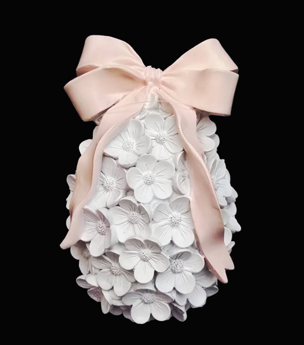 White floral Easter egg decoration covered in intricate white flower detail with blush pink satin bow on dark background — Easter gift Australia Mistletoe Home
