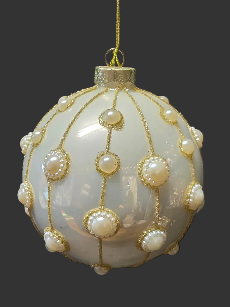 Close up of white pearlescent glass Christmas bauble with intricate gold and pearl bead embellishment on dark background — Mistletoe Home Australia