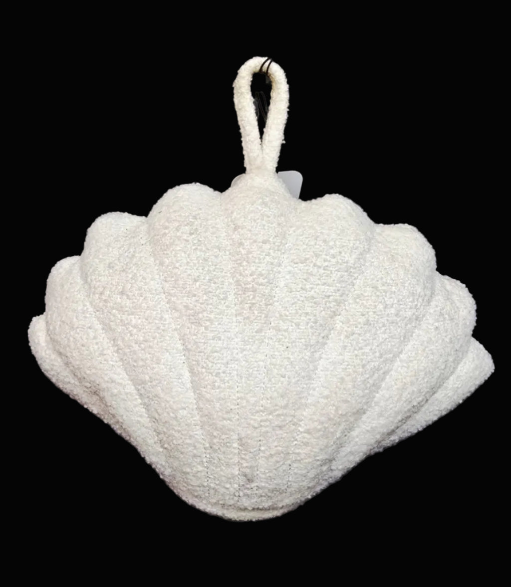 Shell-shaped door stop with a handle on a black background