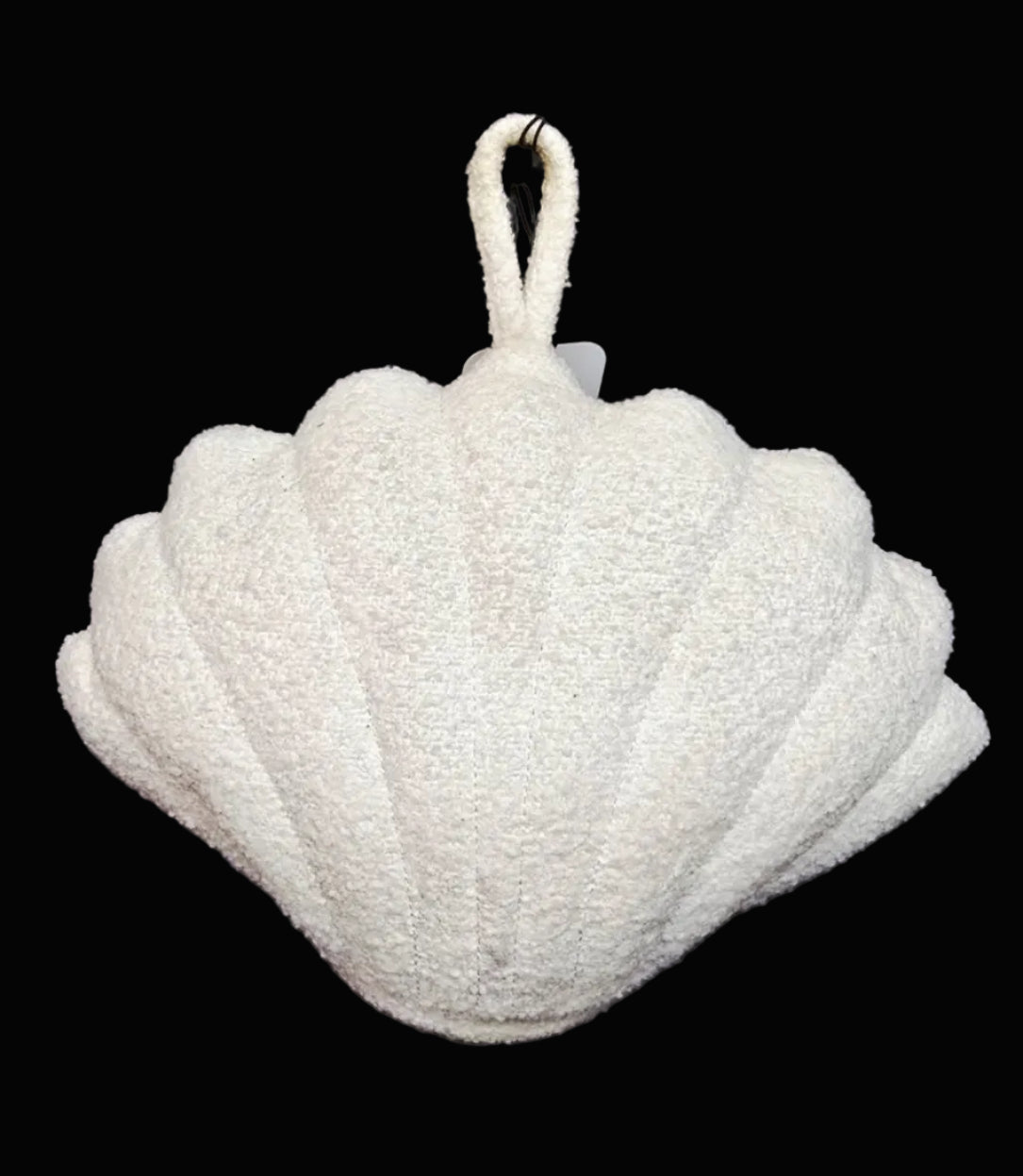 Shell-shaped door stop with a handle on a black background