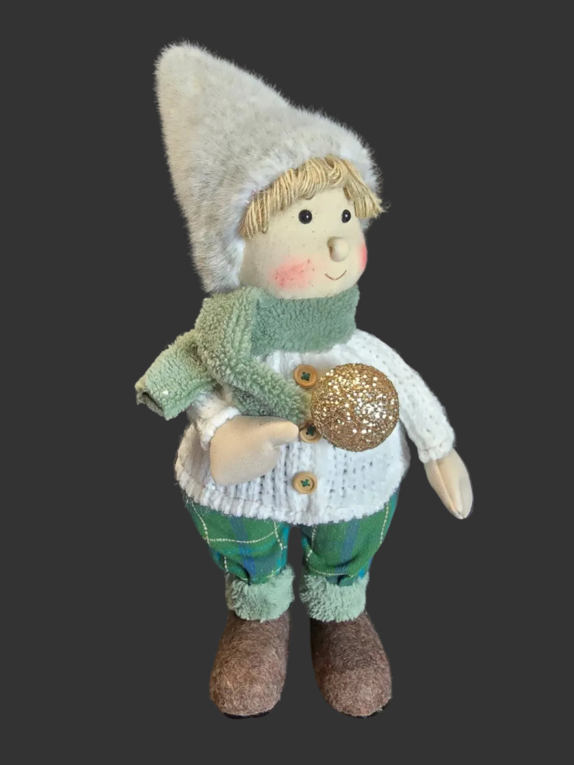 45cm standing Winter Boy Christmas decoration in detailed knit sweater tartan pants and woolly boots holding gold glitter bauble on dark background — Mistletoe Home Australia